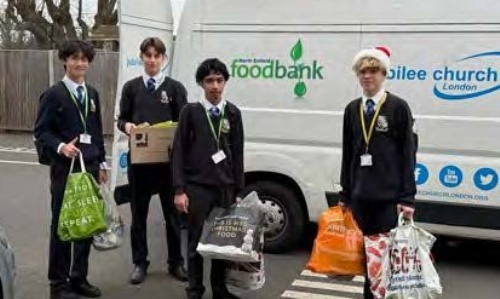 Students bringing bags of food to the food bank's truck